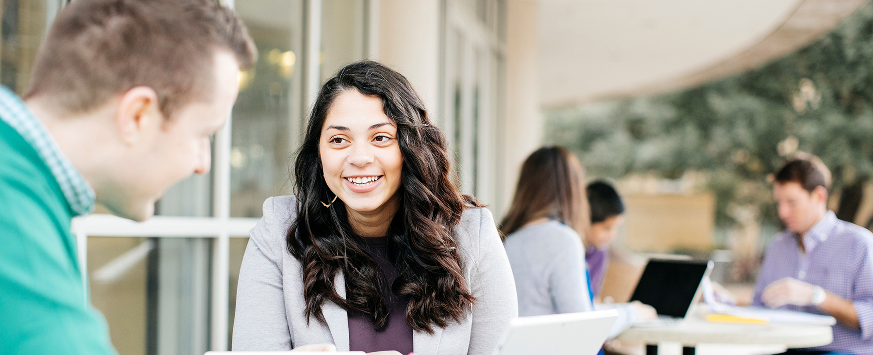 Section Image: MBA students sitting at tables outside of Smith Hall 