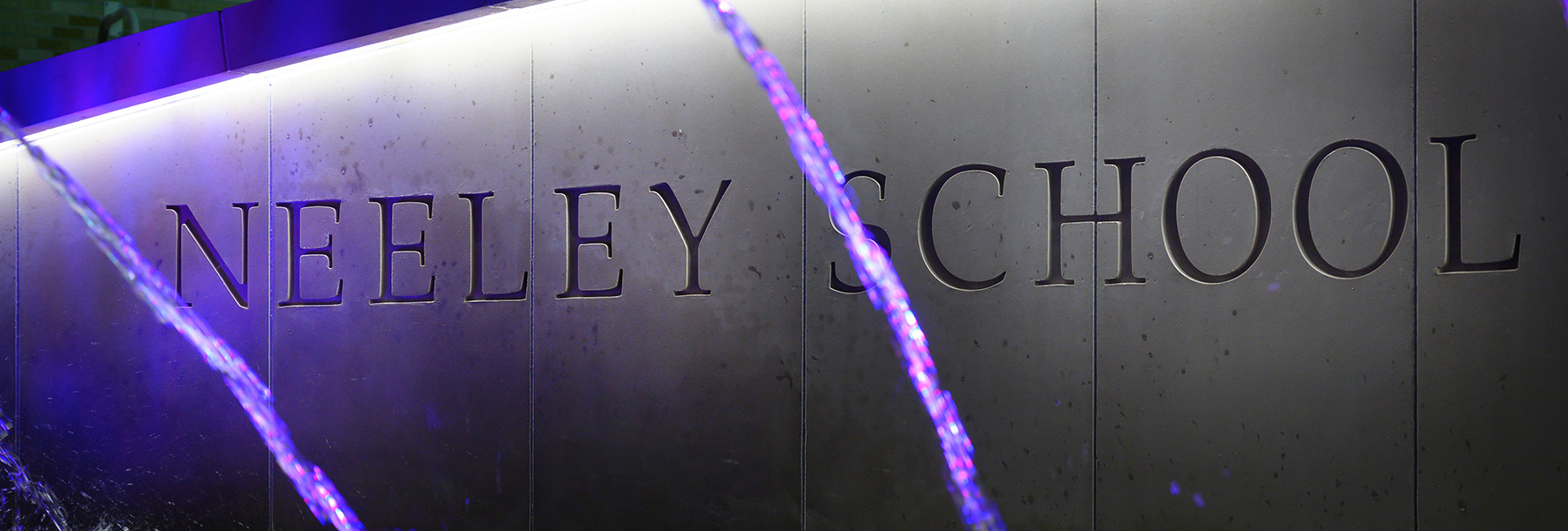 Section Image: Neeley fountain at night with purple lights. 
