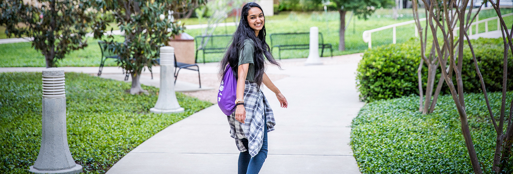 Section Image: Girl on campus smiling 