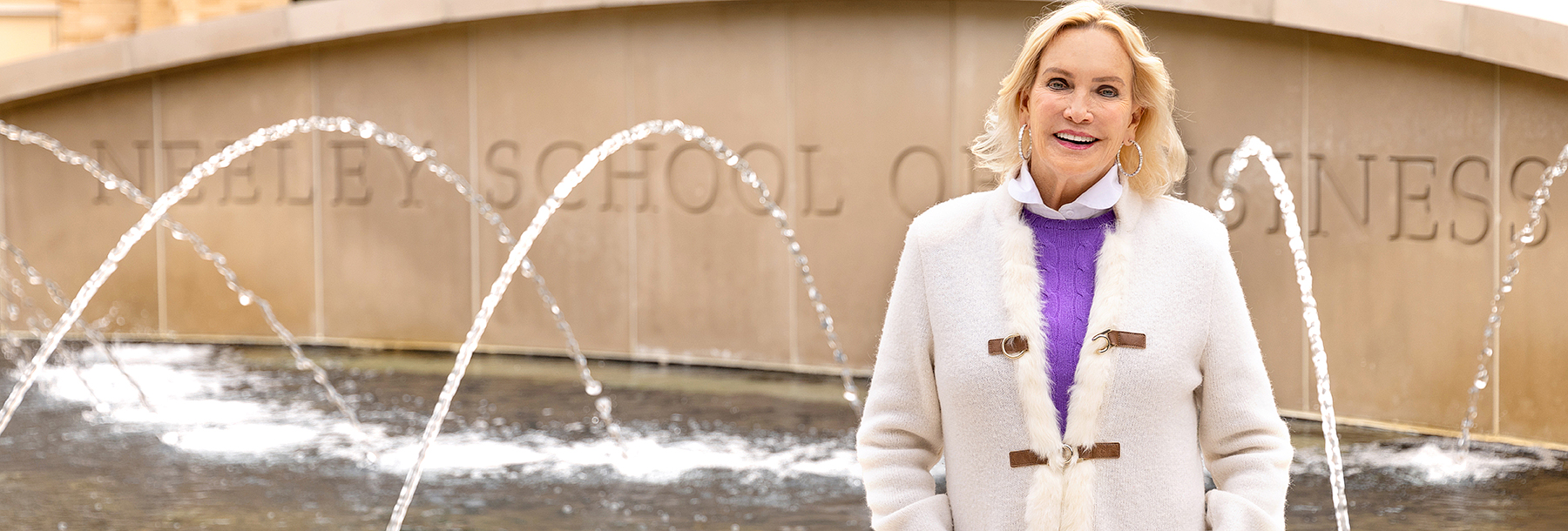 Section Image: Mary Ralph Lowe in front of the Neeley fountain 