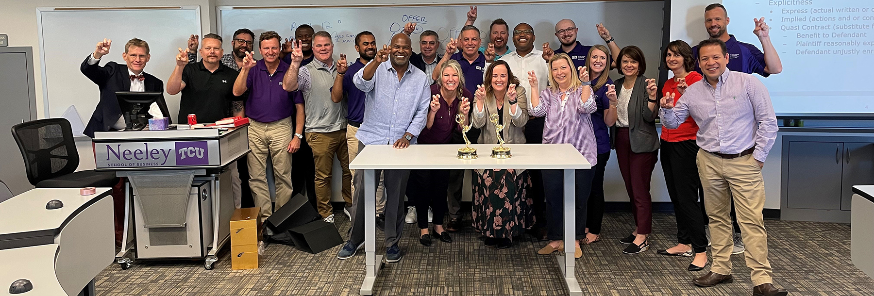 Section Image: Gregg Lehman and the EMBA class celebrate the win of fellow Horned Frog Newy Scruggs. 