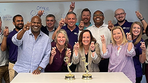 Section Image: Gregg Lehman and the EMBA class celebrate the win of fellow Horned Frog Newy Scruggs. 