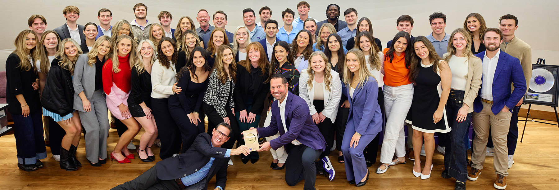 Section Image: Sales Center students and faculty holding trophies. 