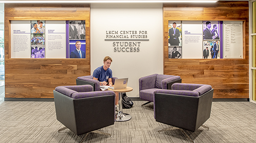 "LKCM Center for Financial Studies" on the wall with student sitting in conversation area