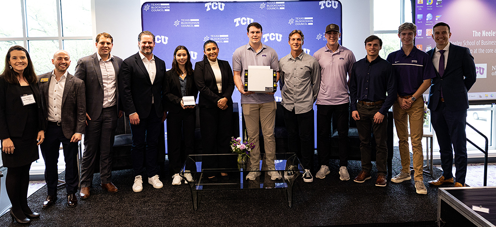 Section Image: Group of TCU students and faculty on the stage at the Bitcoin Mining Summit 