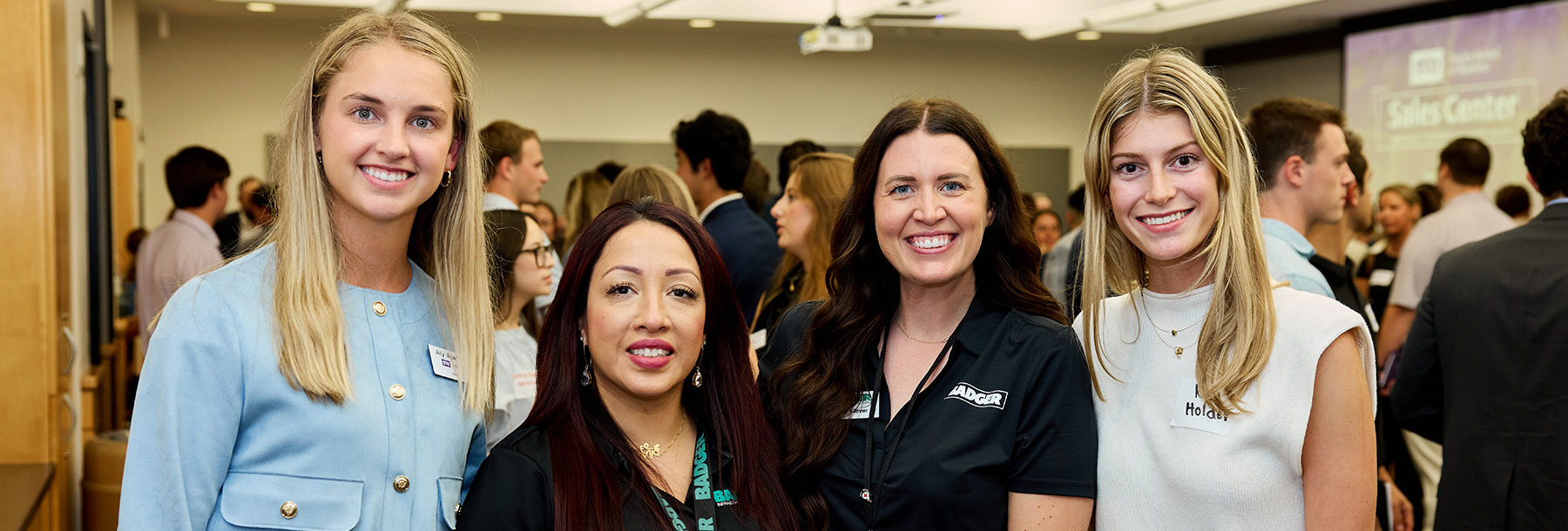 Section Image: Four women, two students and two employers, at a career fair 