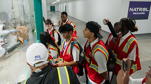 Section Image: Group of BizTech Camper on the tarmac in front of airplanes 