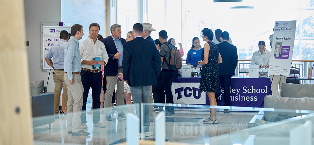 Summit attendees mingle outside the Hays Banquet Room