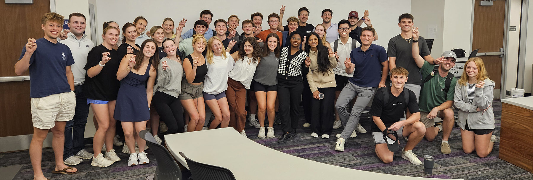 Section Image: Neeley Fellows in a classroom with their Frogs Up. 