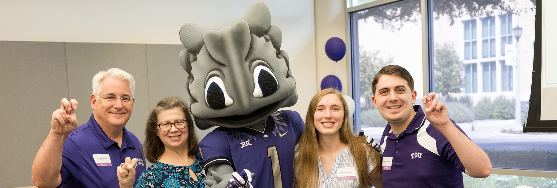 Section Image: Neeley Fellow Claire Ponder and family with Super Frog at Tailgate 