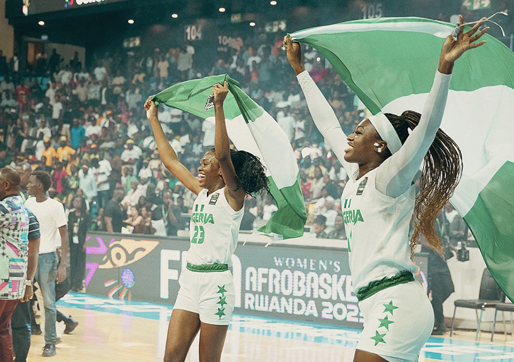 Tomi Taiwo with teammate and Nigerian flag on a basketball court