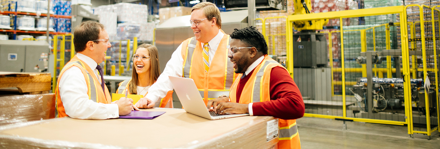 Section Image: Students in orange vests in a wearhouse 