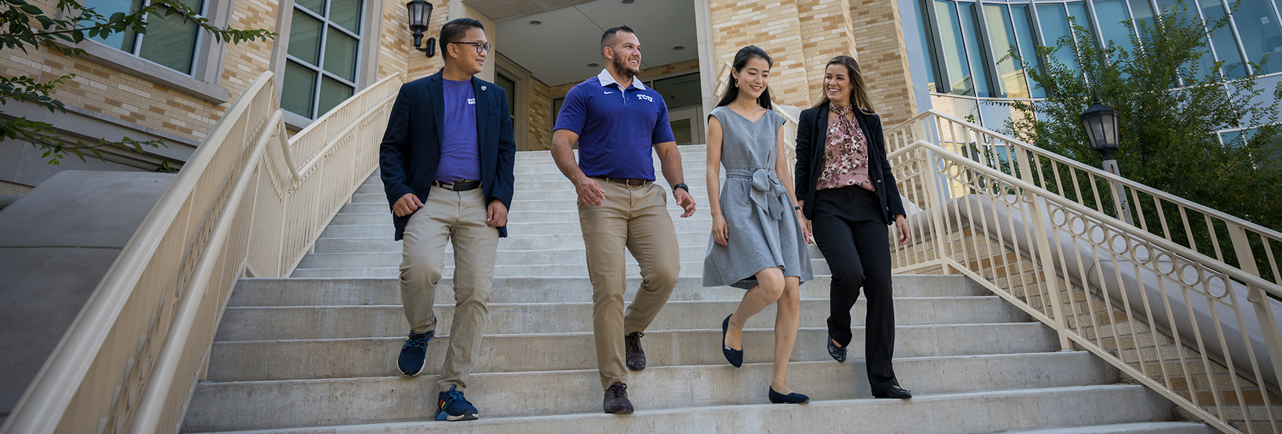 Section Image: Four students walking down the stairs outside the Neeley Business Commons 