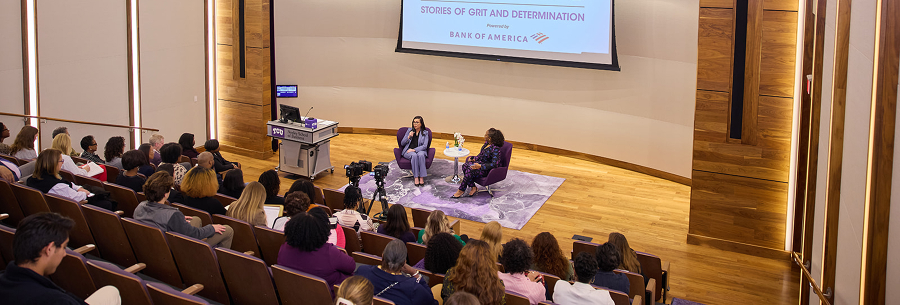 Section Image: Kalisha Holland with moderator Tracy Renee Williams on the stage of the Shaddock Auditorium 