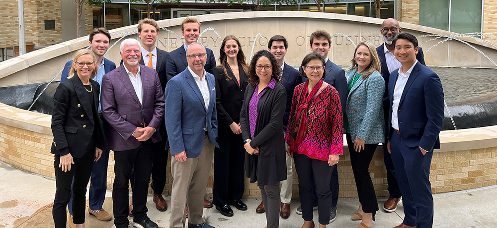 Group of faculty and staff in front of the Neeley Fountain