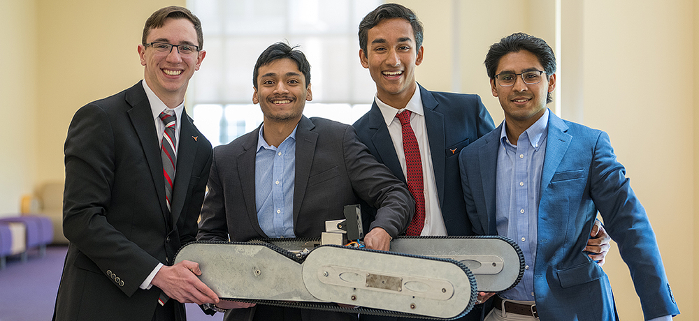 Team of four men holding a tracked robot SIDE HUSTLE