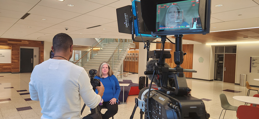 Tracey poses in the Rogers Rotunda while being interviewed.