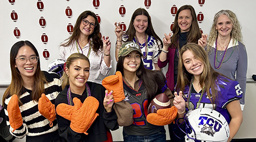 Section Image: TCU students with helmets and mitts 