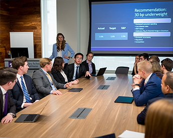 Conference room discussion of a finance presentation
