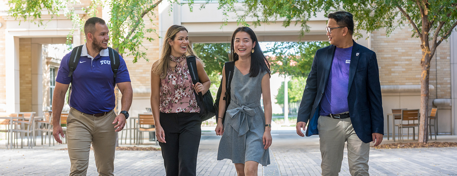 MBA studetns walking and talking on campus