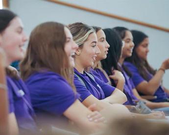 High school students smiling in Analytics Academy lesson