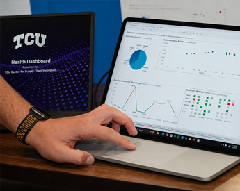 Neeley student and faculty discussing data shown on a laptop