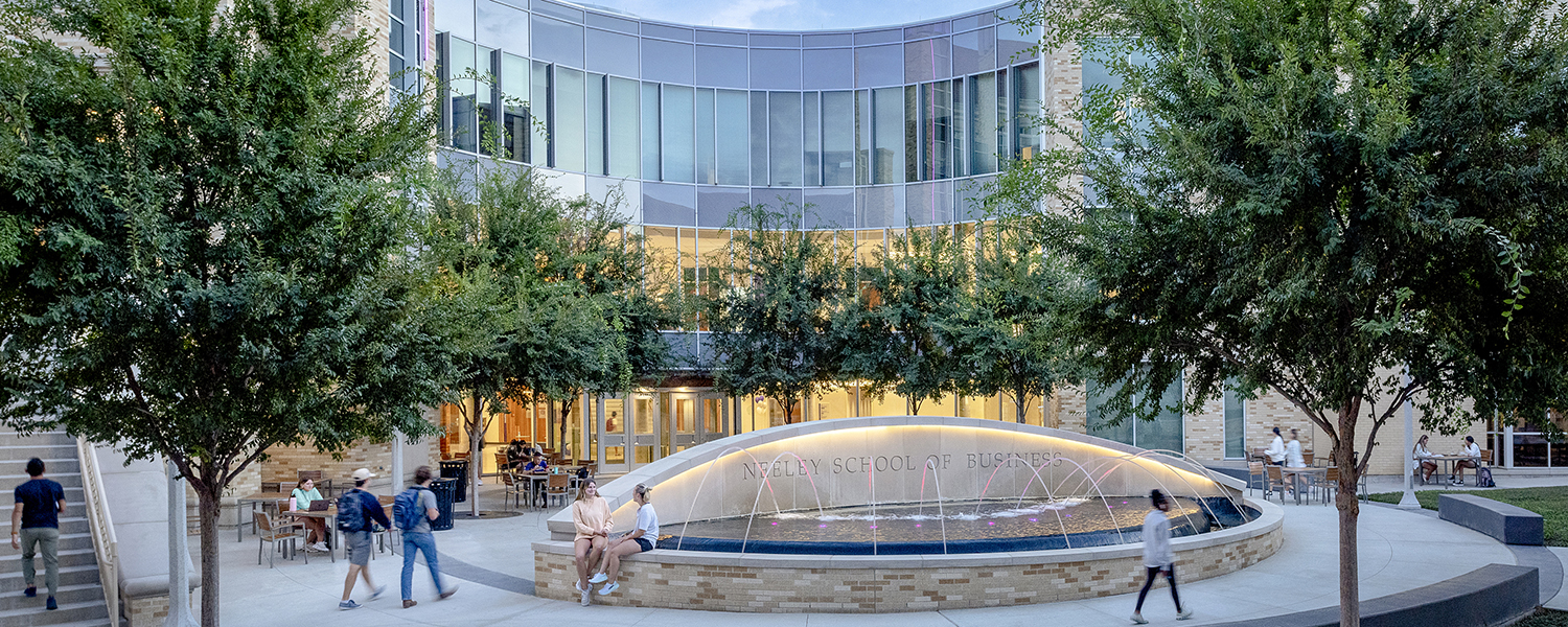 Neeley students walking in front of fountain