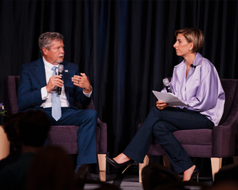 Panel of energy industry leaders speaking on stage
