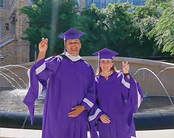 Fields family mother and son posing in their graduation cap and gowns