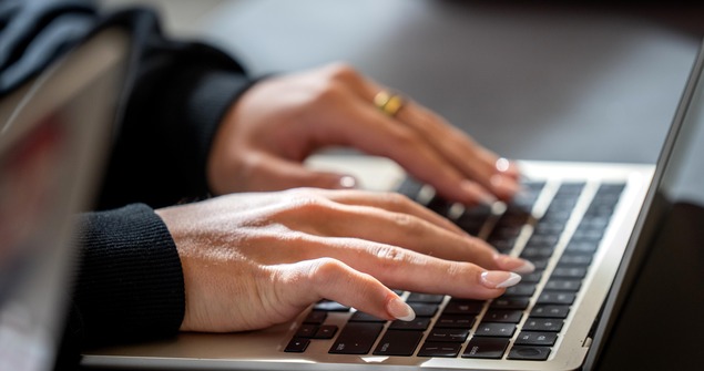 Student typing on computer