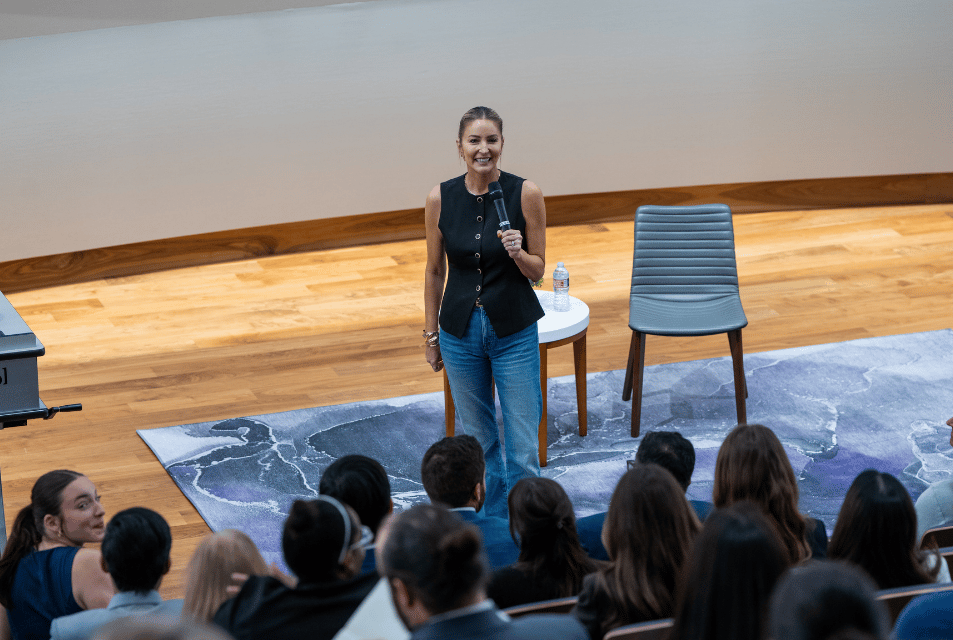 A speaker at the inaugural Neeley AI Symposium speaks to the audience about applying AI in the business industry. 