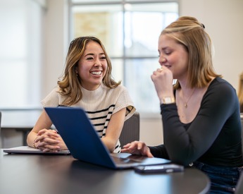 Students smiling and working together