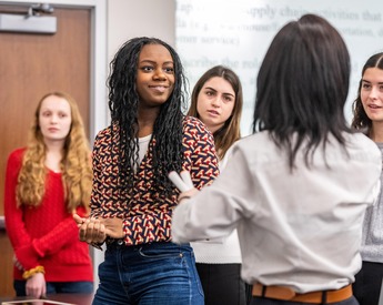 Students engaging in interactive supply chain lecture with TCU Neeley professor