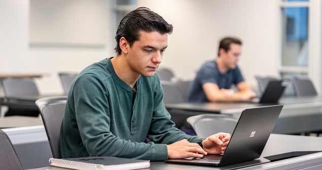 Departmental honors student working on laptop