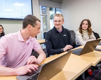 Students discussing classwork in an accounting class