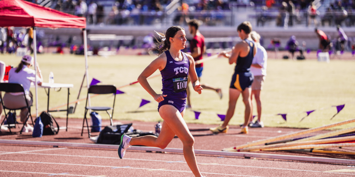 Female track athlete in TCU uniform runs down the track during a competitive race.