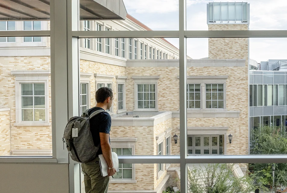 Student looks out onto the Neeley plaza