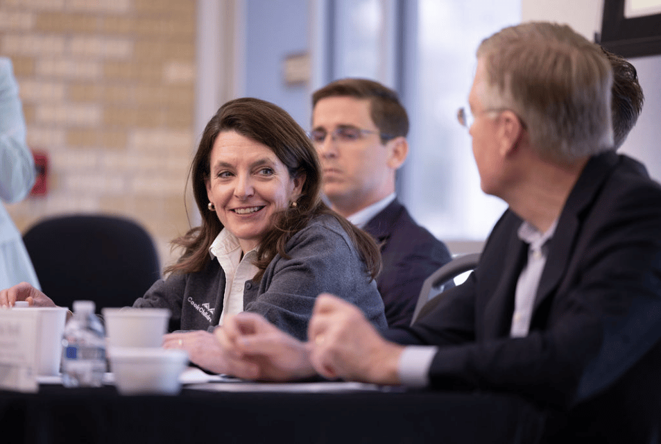 Man and woman interact while attending a celebration for the long-standing partnership with Cook Children's and TCU Neeley's Executive Education program.