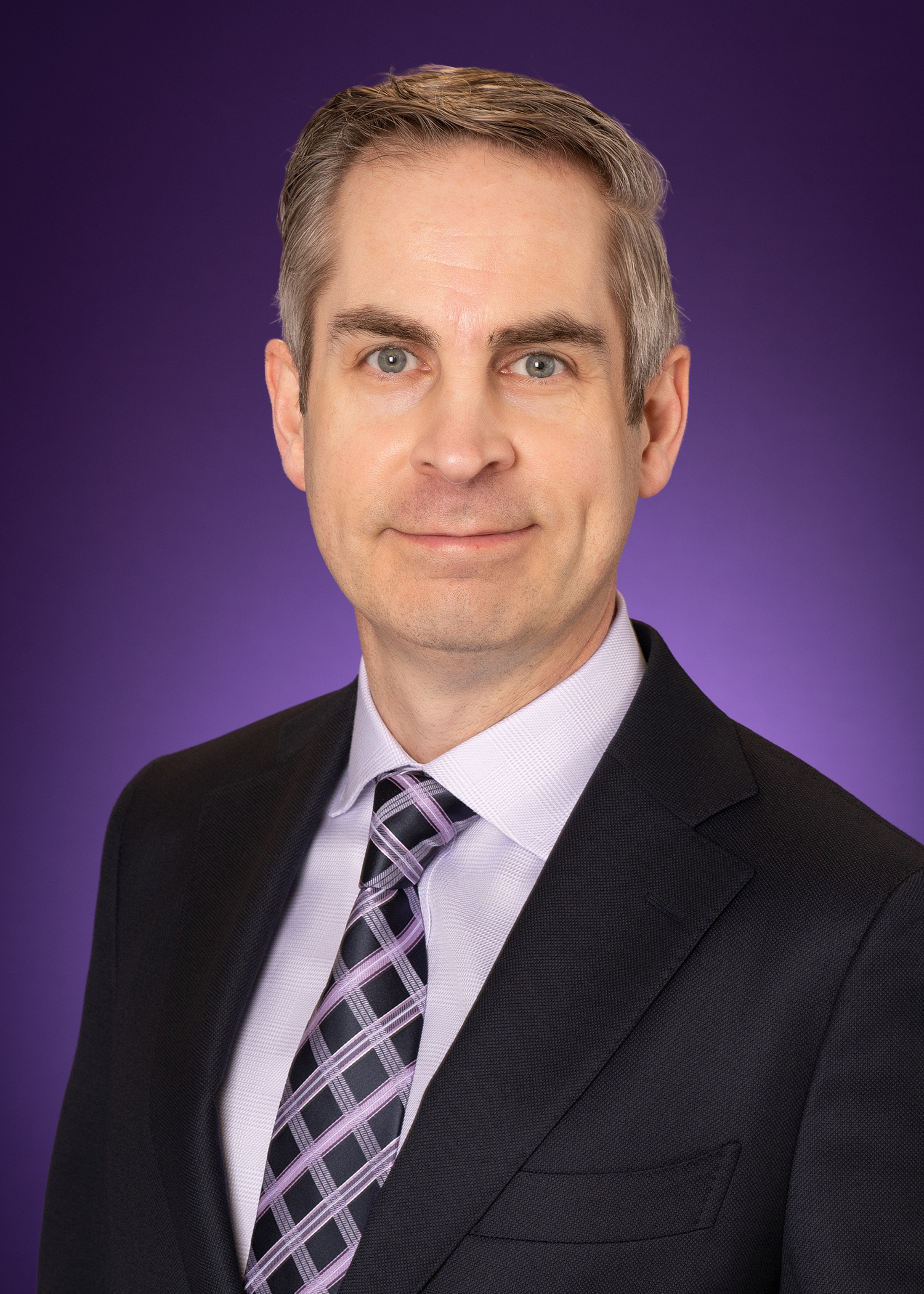 Tyson Browning headshot with purple background.