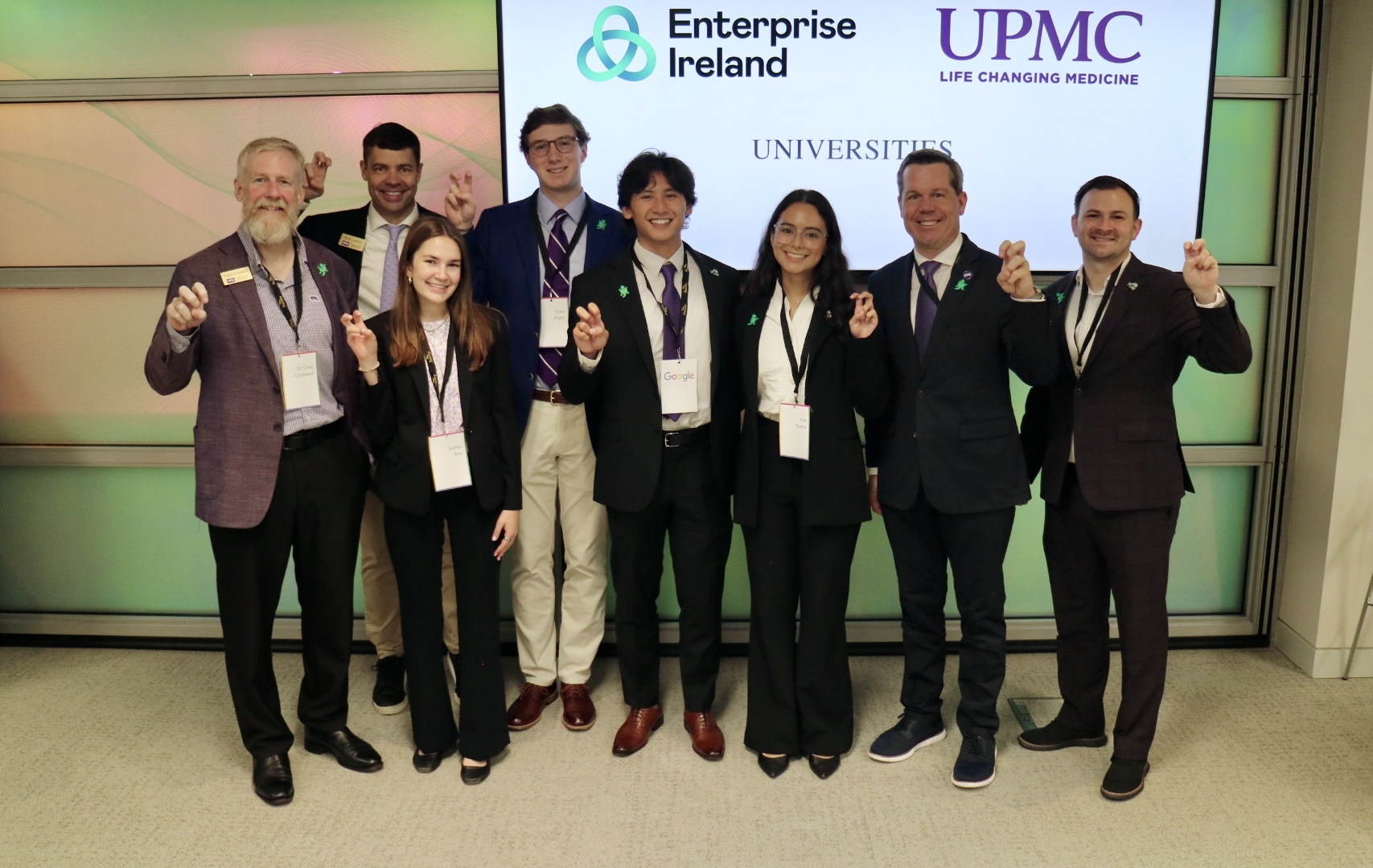Neeley undergraduate students show Horned Frogs hand signal at Ireland business case competition. 