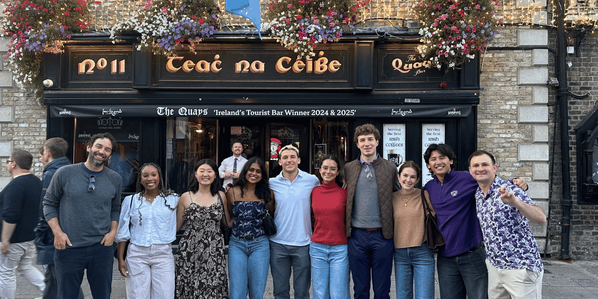 Neeley students and staff members post outside a pub in Ireland while overseas for a business case competition.
