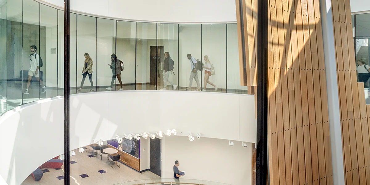 Students walking around the Rogers Rotunda on the second floor