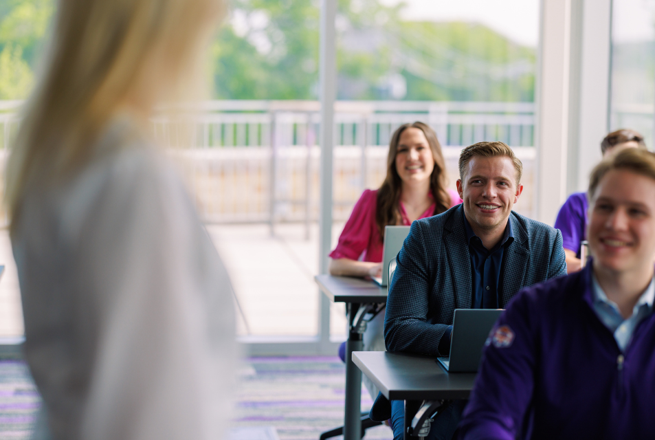 Students in class looking at professor during instruction. 