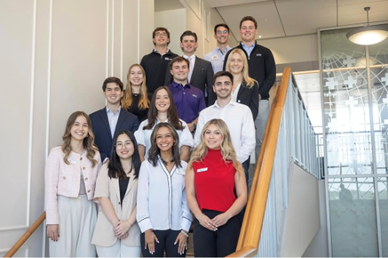 Undergraduate student leaders of Welcome 2 Neeley pose on staircase together.